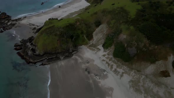 Ocean Beach At Whangarei Heads On A Gloomy Day In Northland, New Zealand. - aerial, tilt up alt