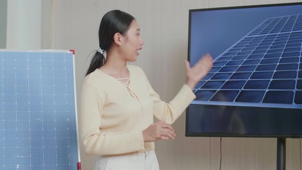 Asian Woman Engineer Presenting About The Work Of Solar Cell At The Office alt