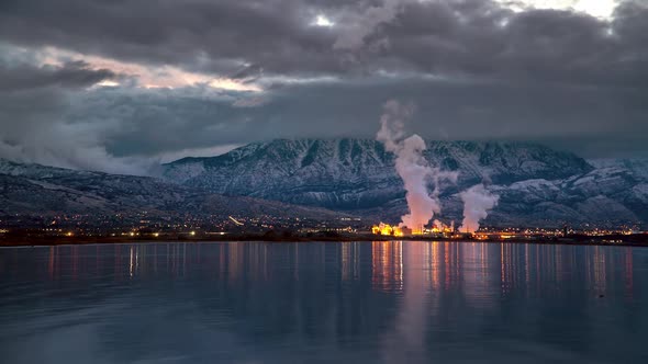 Time lapse looking across lake at city during dawn in winter alt