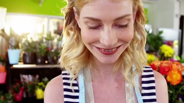 Portrait of female florist smiling in flower shop alt