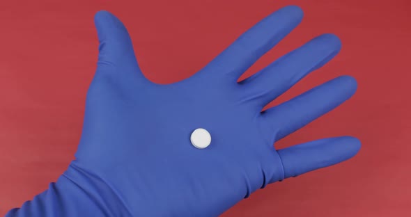 Doctor Hand in Medical Glove Gives a White Pill and Receive Cash Payment alt