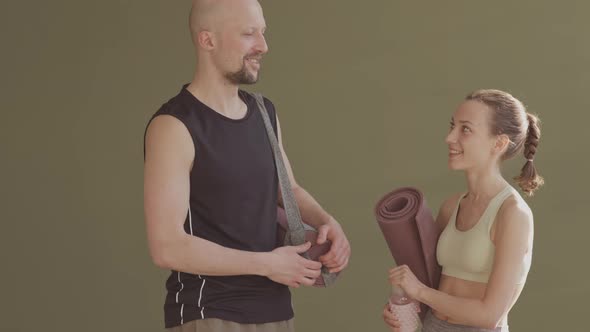 Man with Prosthetic Leg and Female Coach Talking after Yoga Practice alt