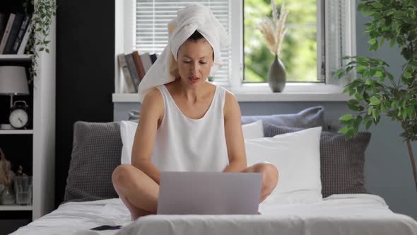 Woman with Laptop at Bedroom