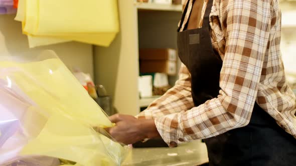 Female florist preparing flower bouquet in flower shop 4k alt