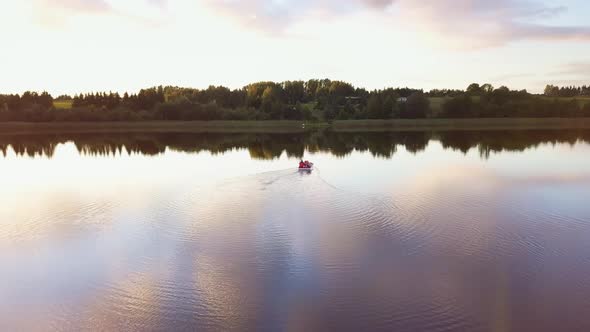 Family on a Pedal Boat on a Lake at Sunset.