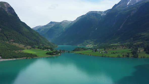 Amazing panoramic view of Oldevatnet glacial lake surrounded by tall mountains - Norway aerial alt