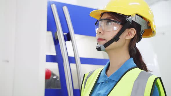 Asian woman worker people wearing protective safety helmet and glasses in production room in factory alt