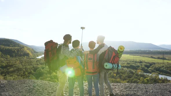 Two Attractive Couple Posing on the Smart Phone Camera in the Mountain alt