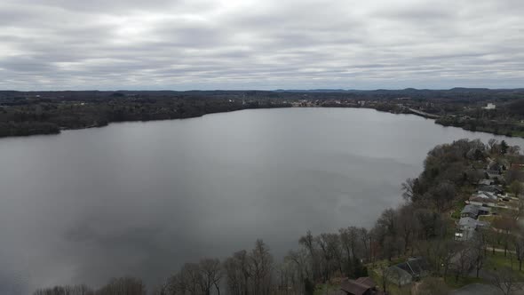 View over lake on a gray cloudy day in the midwest. Light waves seen on the lake.