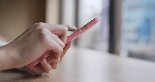 Woman use of mobile phone in coffee shop alt