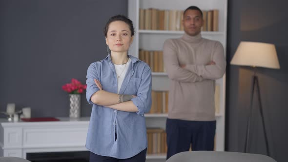 Portrait of Proud Confident Caucasian Woman Looking at Camera Crossing Hands with Blurred African alt