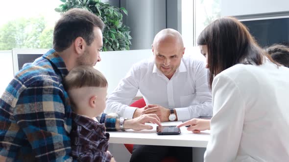 A Large Family Takes a Mortgage From a Bank Buying a Home on Credit alt