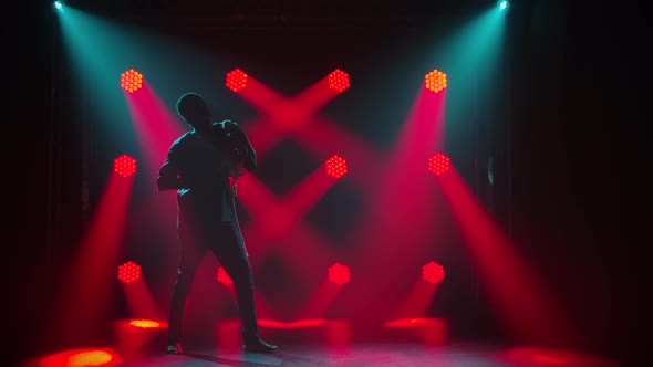 Happy Smiling African American Man Playing the African Talking Drum Yuka and Dancing in a Dark alt