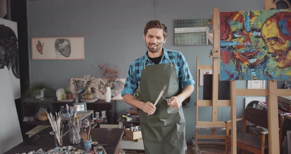 Happy Artist Dancing in Studio