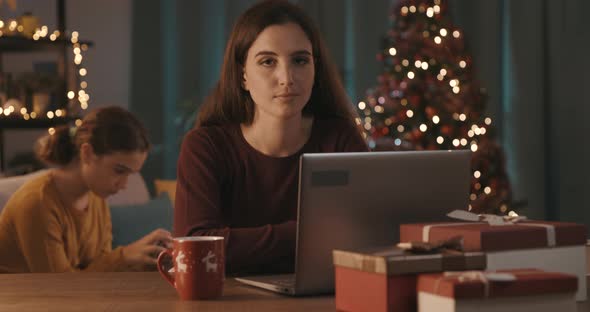 Smiling woman connecting online on Christmas day