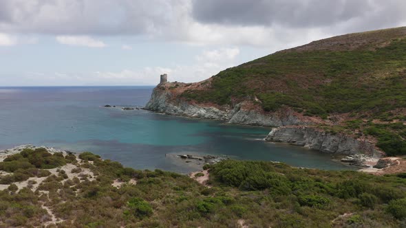 Aerial View of White Rocky Coast with Old Ancient Stone Tower Lighthouse Building alt