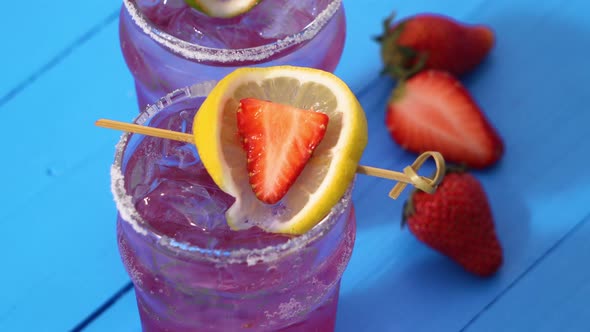 Colorful blended summer drink cocktails with fresh strawberry and lemon