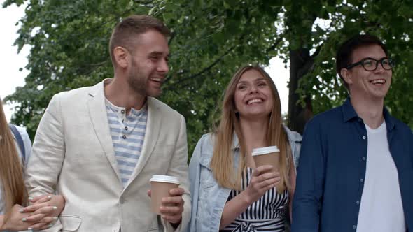 Young Couples Walking and Chatting Outdoors alt