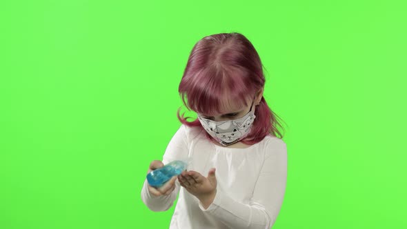 Little Girl in Medical Face Mask. Uses Hand Sanitizer. COVID-19 Coronavirus alt
