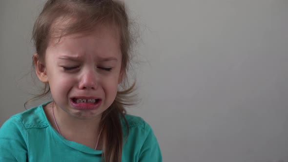 Portrait Little Girl Sad Upset Child Burst Into Tears Cries Sob Looking at Camera Indoors alt