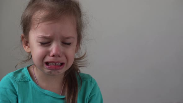 Portrait Little Girl Sad Upset Child Burst Into Tears Cries Sob Looking at Camera Indoors