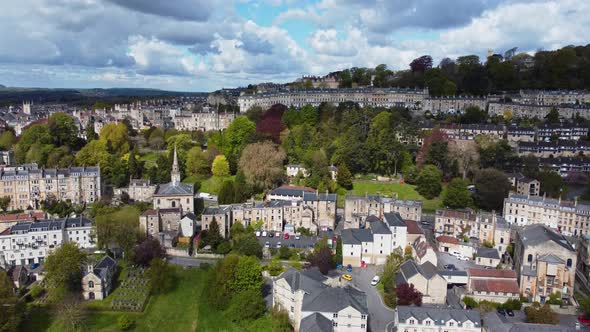 Rising aerial looking overa residential area in Bath, Somerset, including the stunning Camden cresen alt