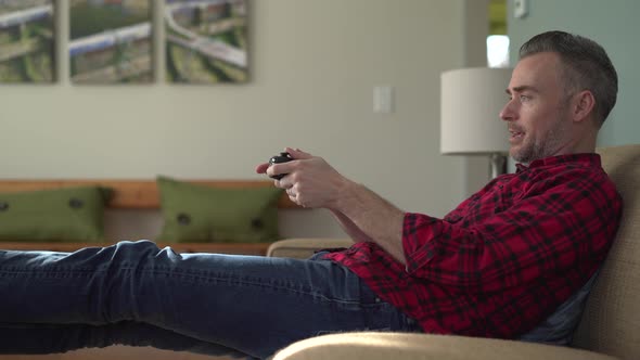 Man Enjoys a Video Game After Work
