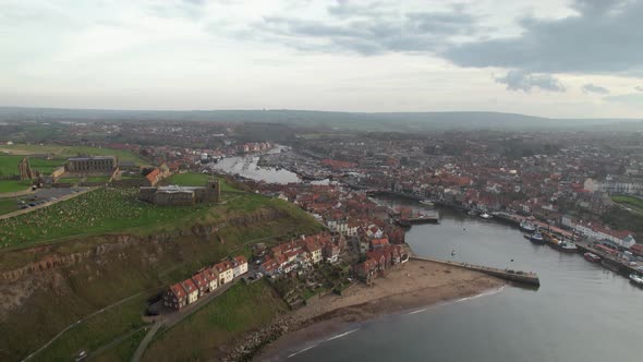 Aerial view of Whitby Harbour. Here we can see a narrow stream many houses are seen on either side o alt