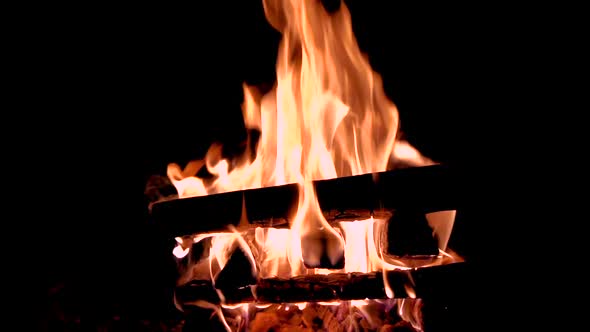 Hot fireplace full of wood. Real Flames from burning logs in slow motion