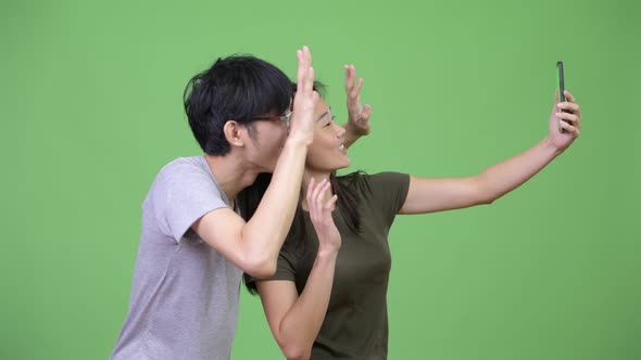Young Asian Couple Showing Phone Together
