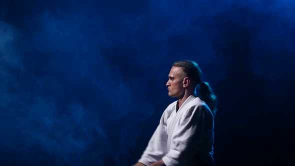 Man Fighting at Aikido Training with Japanese Sword Katana in Martial Arts School. Healthy Lifestyle alt