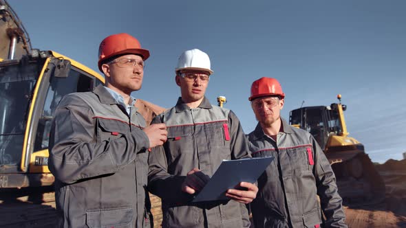 Industrial Male Worker Working in Team at Construction Site Outdoor Medium Shot alt