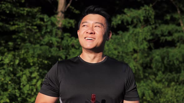 Korean Sportsman Feels Good After Workout on Nature on Sunset Outdoors alt