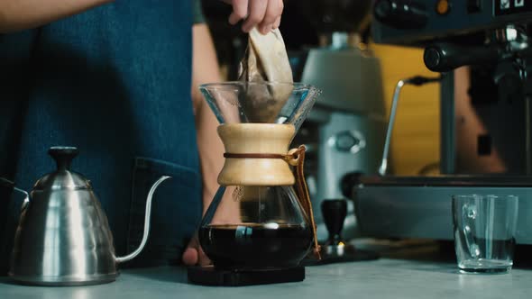 Process of making espresso in a coffee machine. Barista making latte in  specialty coffee shop. alt