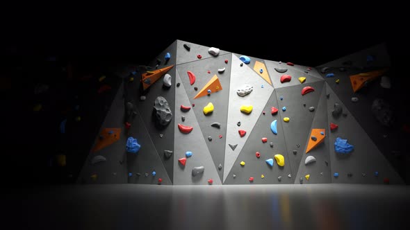 Indoor bouldering wall with colorful climbing holds. Gym indoor extreme training alt