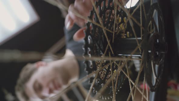 Mechanic Repairing Bicycle Wheel in Workshop