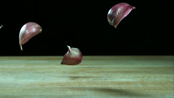 Garlic clove pieces bouncing in ultra slow motion 1500fps on a wooden surface - BBQ PHANTOM 033 alt