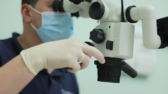 Doctor Making Teeth Examination Research Survey Using Microscope in Dentistry
