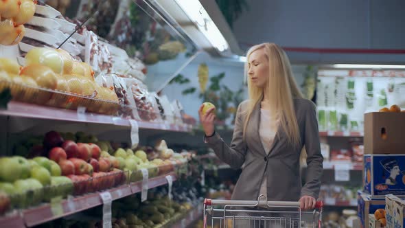 Beautiful Young Woman with Trolley Shopping in Supermarket alt