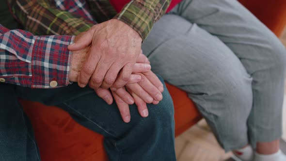 Close Up of Caring Elderly Grandmother Wife Holding Hands Supporting Senior Grandfather Husband alt