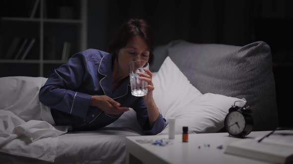 Woman Taking Pills for Sleep