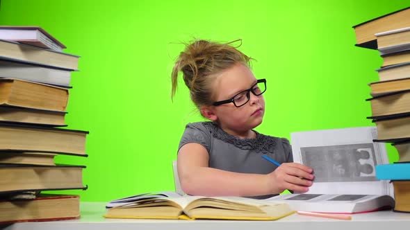 Girl Leafing Through the Pages of Books Carefully. Green Screen. Slow Motion alt
