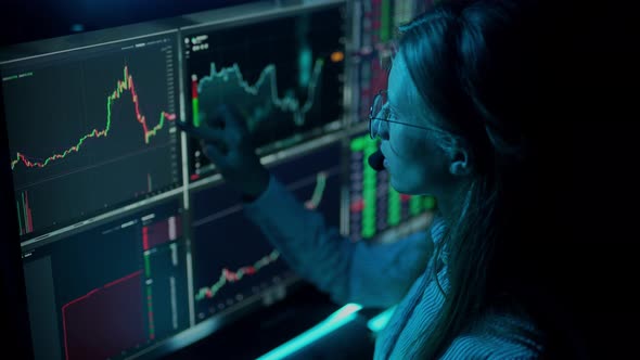 Trader is Working with Multiple Computer Screens with Charts and Data Analysis and Stock Broker alt