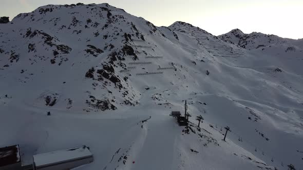 Snowy Mountain Skilifts and Furniculars and Skislopes in Austrian Alps Drone Flyover the Mountains