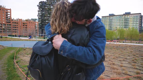 Slow motion two caucasian friends or lovers outdoor in a romantic embrace