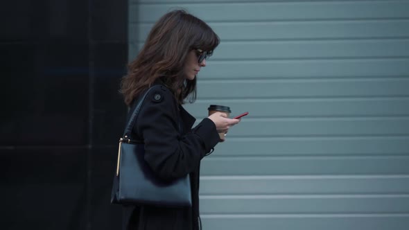 Slow Motion Profile of Business Woman in Sunglasses with a Cup of Coffee alt