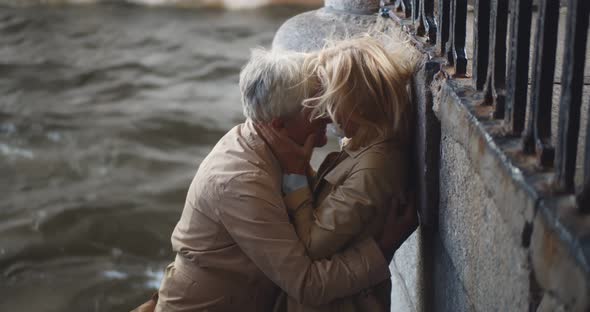 Passionate Mature Couple Making Out Near City River alt