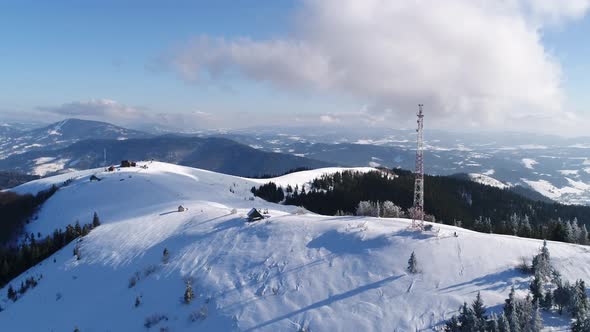 Flying Over Radio Communications Tower, Mountain Snow Covered Winter Landscape alt