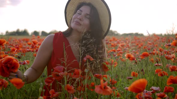 Beautiful Happy Young Woman in a Poppy Field