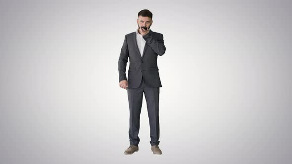 Businessman Using Speak Activate Virtual Digital Voice Assistant on Smartphone on Gradient alt